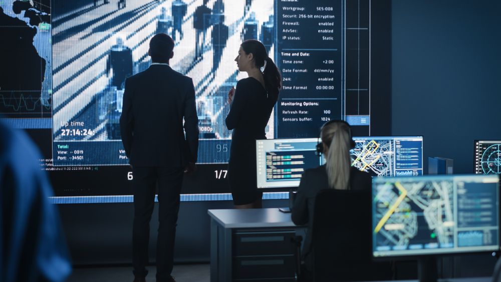 Executives Analyze Financial Data on Large Screen in High-tech Operations Room.