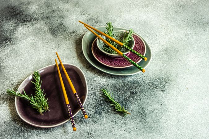 Asian table setting with chopsticks and rosemary