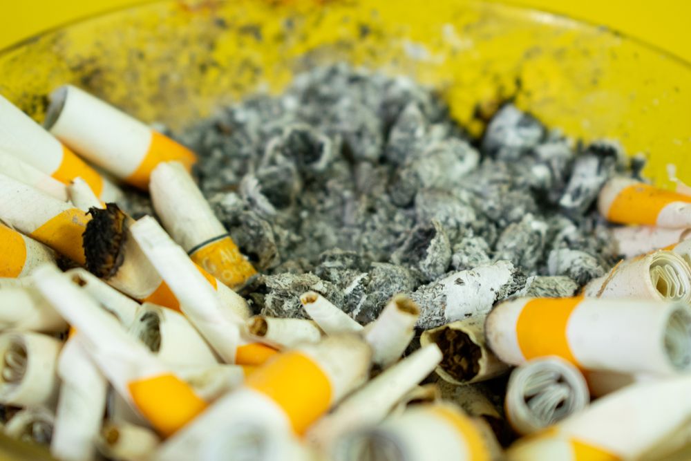 Close up of ashtray filled with cigarette butts