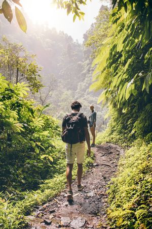 Man and woman hiking on forest trail