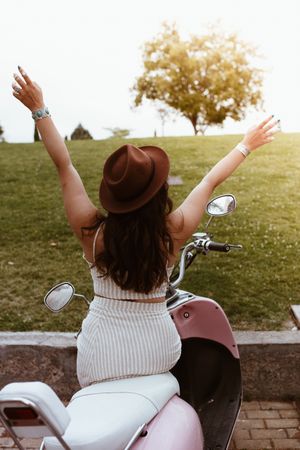 Woman spreading arms wide open to sun