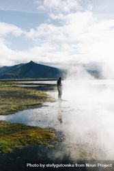 Man at geyser on overcast day, portrait 4mOqB0