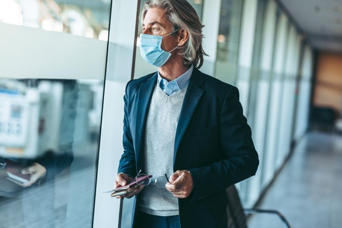 Businessman waiting for his flight during coronavirus outbreak