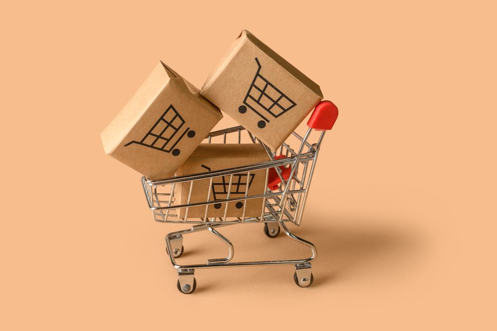 Shopping Cart with Small Boxes Represents Online Retail and Delivery