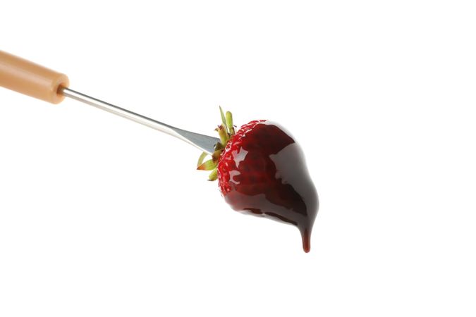 Chocolate fondue. Strawberry in chocolate sauce isolated on plain background