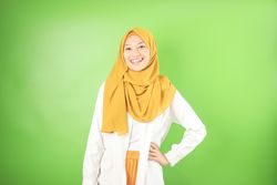 Smiling Female Standing with Veil While Her Hand on Hips