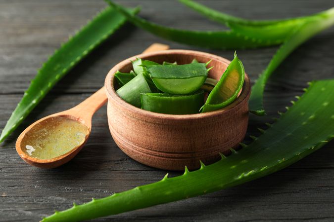 Aloe vera leaves and slices on wooden table, closeup. Natural treatment