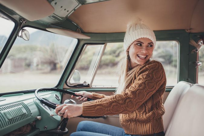 Attractive woman on roadtrip traveling by a van