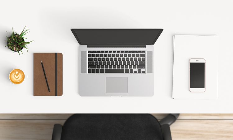 Modern workplace with laptop, coffee cup and smartphone or tablet copy space on table background. Top view. Flat lay style.