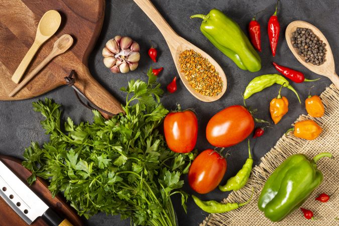 Ingredients for cooking with tomatoes, various peppers, garlic and green peppers.