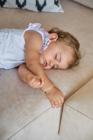 Cute toddler having nap on couch