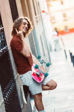 Man carrying longboard on the street