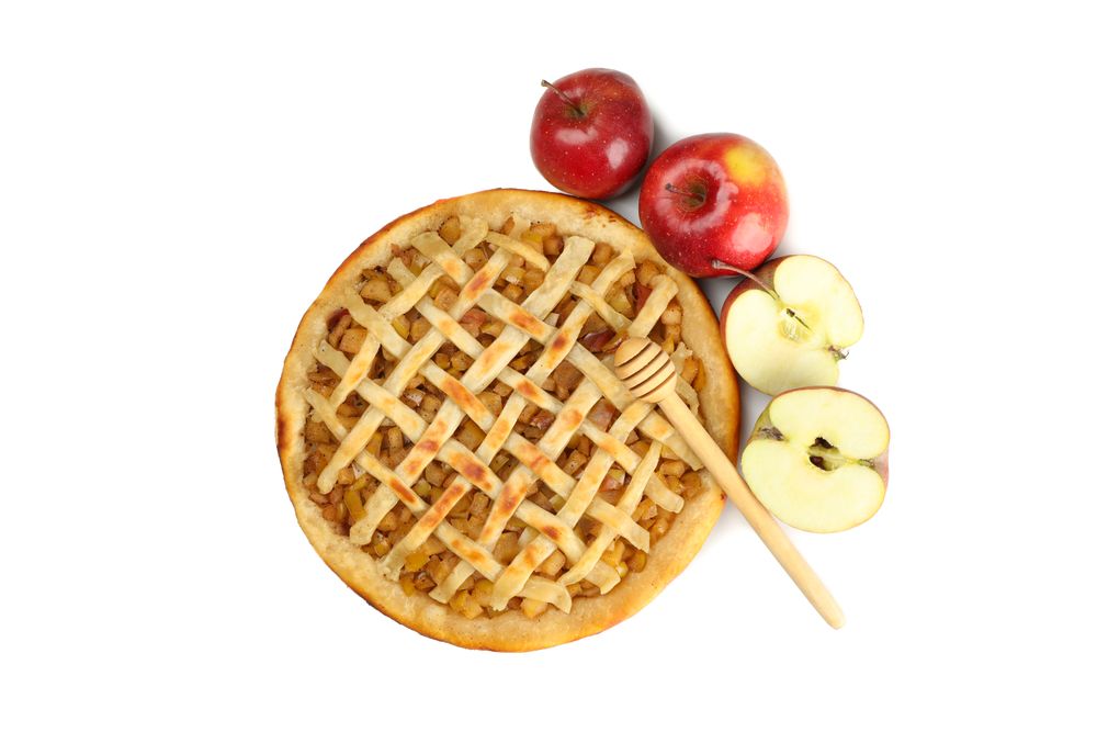 Tasty apple pie, apples and dipper isolated on blank background