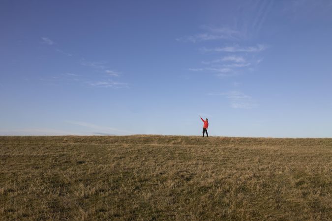 Man pointing at sky from field