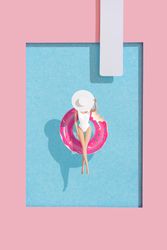 Barbie-like doll in donut ring in pool