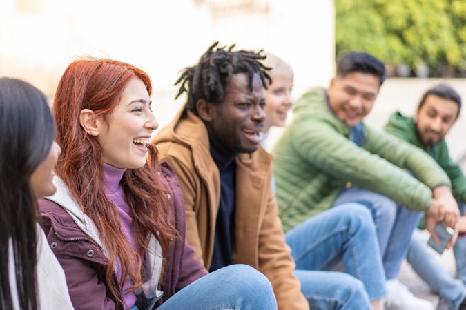 Group of diverse friends sitting outside