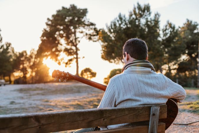 Man playing the guitar on the outside