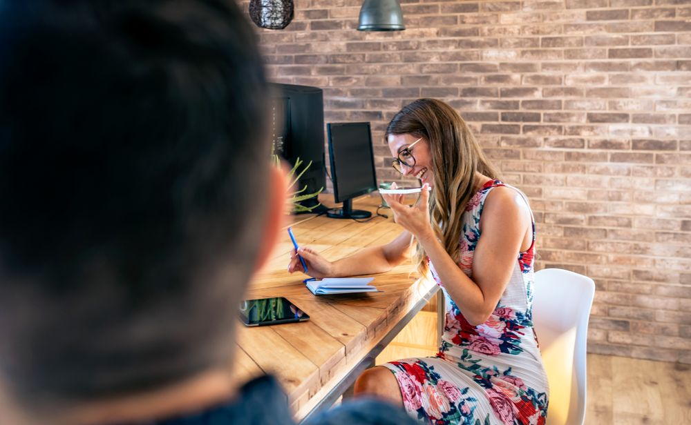 Office worker talking mobile phone with speaker