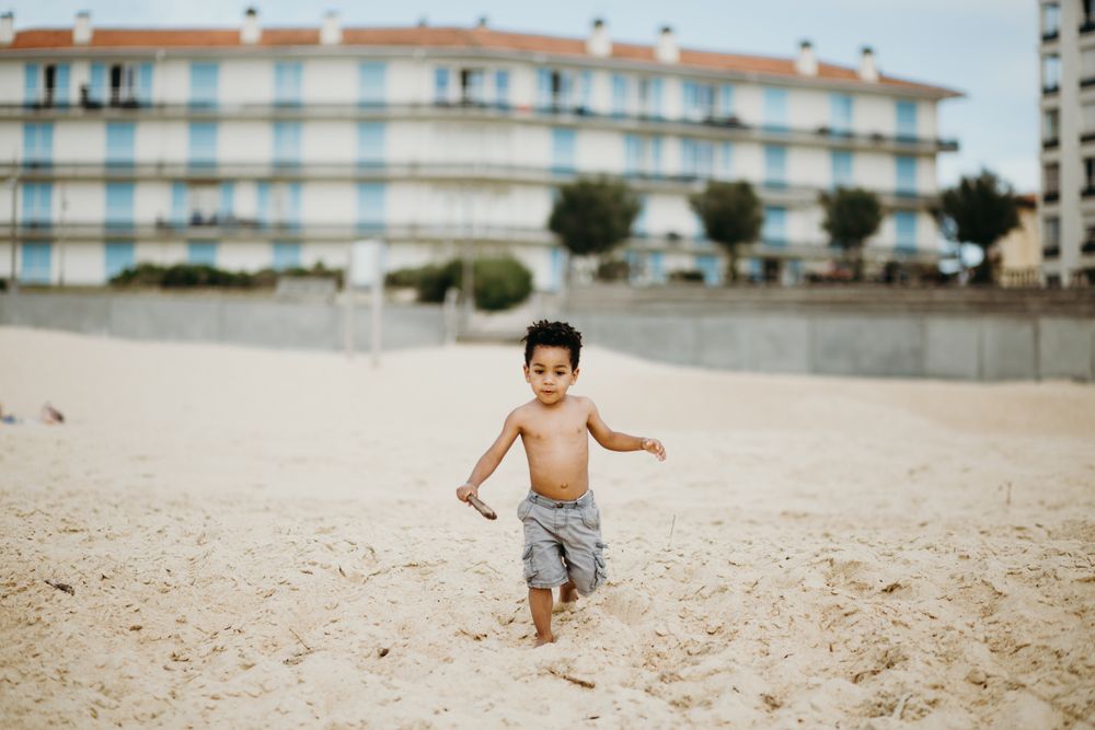 Black boy playing on beach