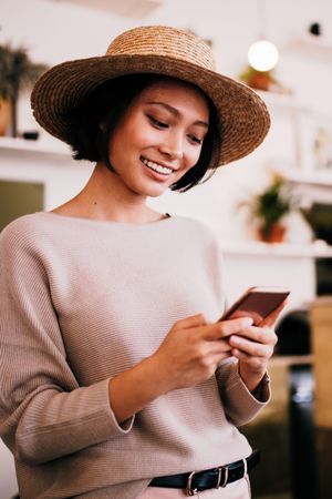 Young woman smiling while looking at a mobile phone