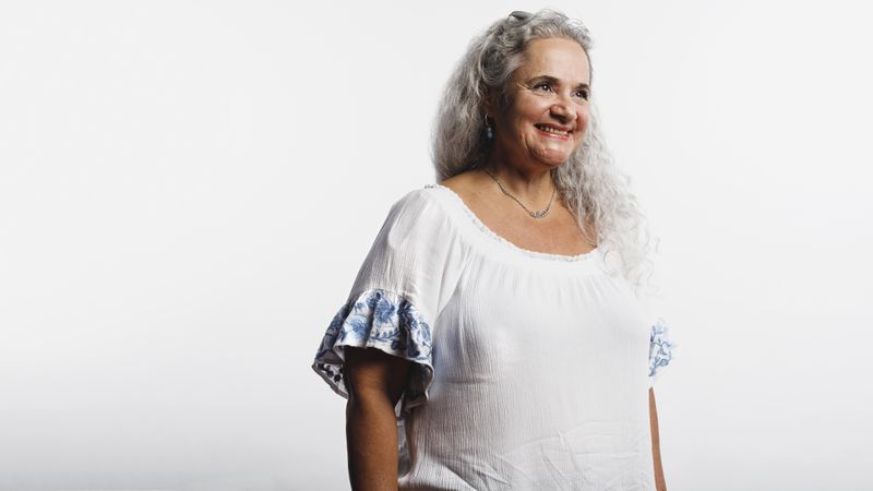 Smiling woman in white hair isolated on a neutral background