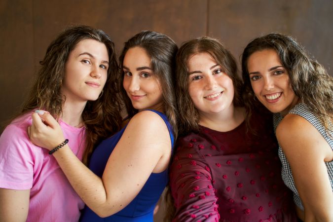 four smiling friends taking a selfy