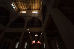 Woman praying in dark church