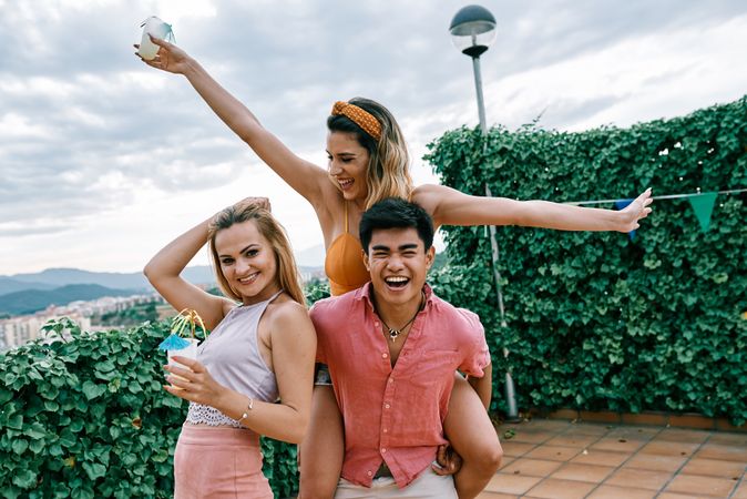 Happy man carrying his girlfriend on the back and having a good time