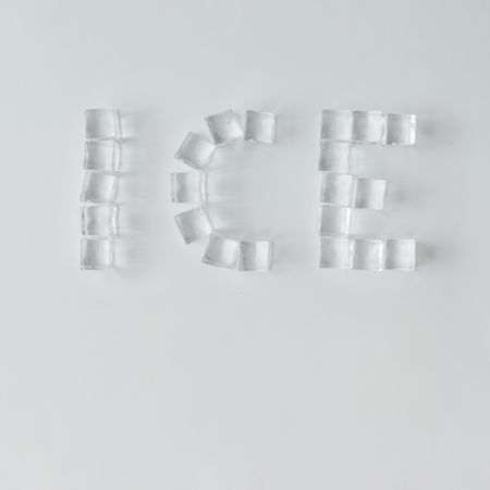Ice cubes making “ICE” word on bright background