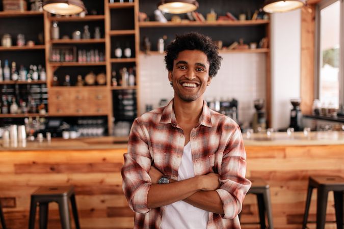 Smiling guy standing in a coffee shop