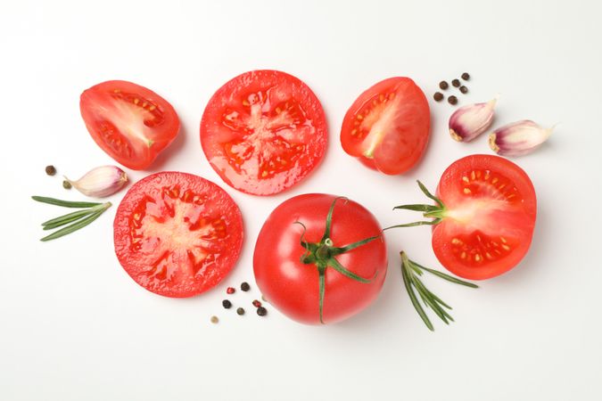 Tomatoes and ingredients on neutral background, top view