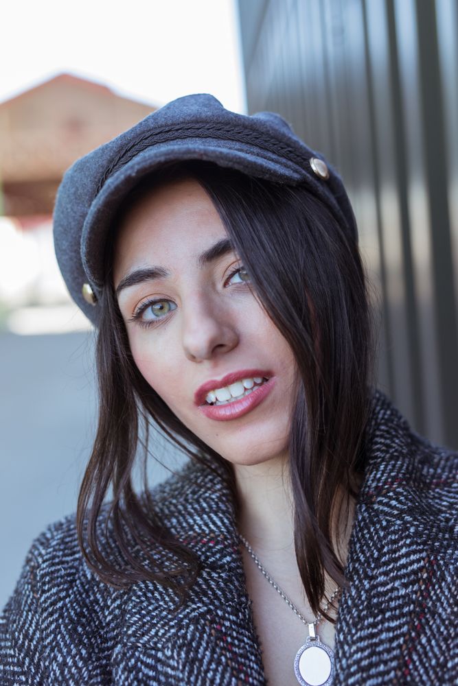 Charming Hispanic woman near wall