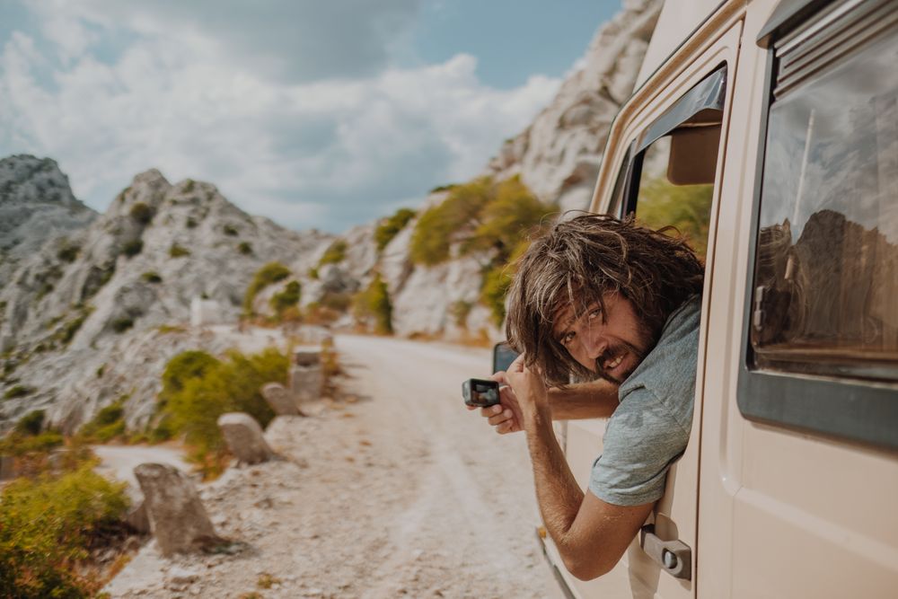 Man looking back from window car