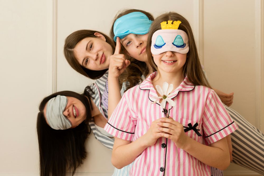Girls peeking from behind another girl