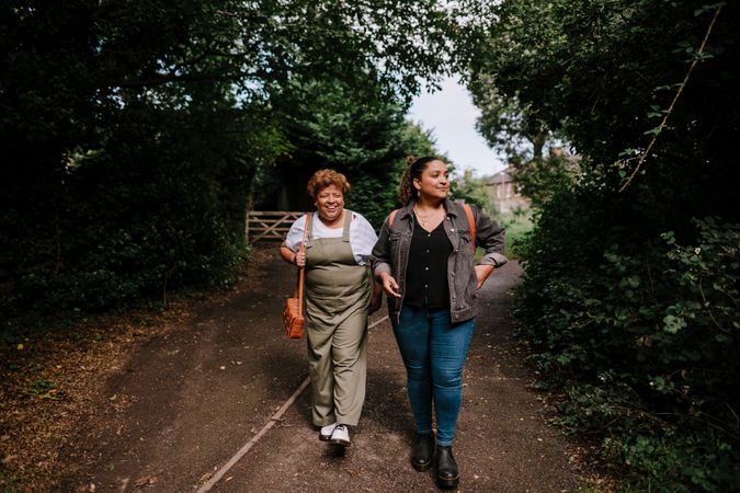 Two women walking down a country road
