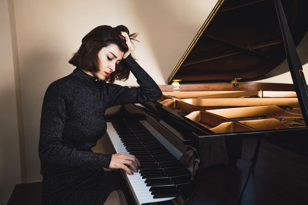 Young woman playing on piano