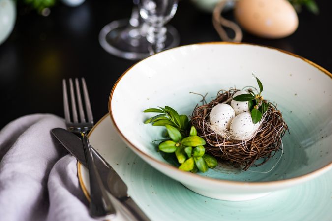 Elegant ceramic plates for spring themed table with nest ornament