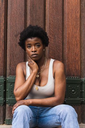 Sad Black woman with Afro hairstyle looking at camera