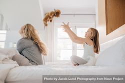 Mother and daughter playing with teddy bear in bedroom at home 4M39G0