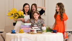 Group of children celebrating birthday party with cake.