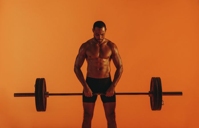Weight lifting man working out using barbell