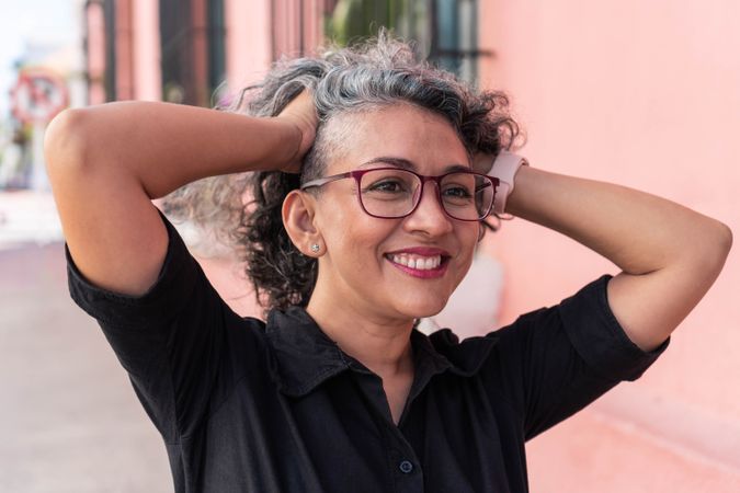 Gray-haired woman laughing outside
