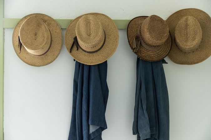 Men's straw hats, hanging inside the farmhouse at Yoder's Amish Home, Walnut Creek, Ohio