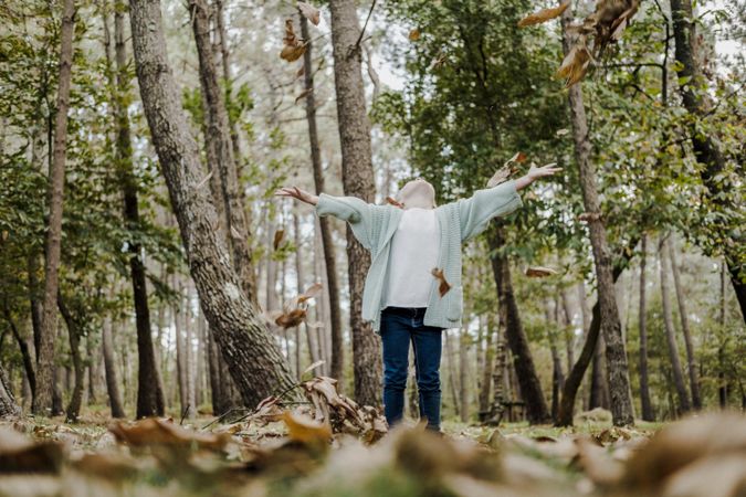 Smiling girl between meadow with dry leaves