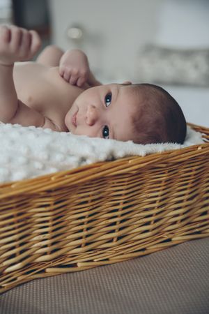 Baby lying in a wicker basket