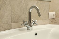 Sink and faucet in modern bathroom, close up