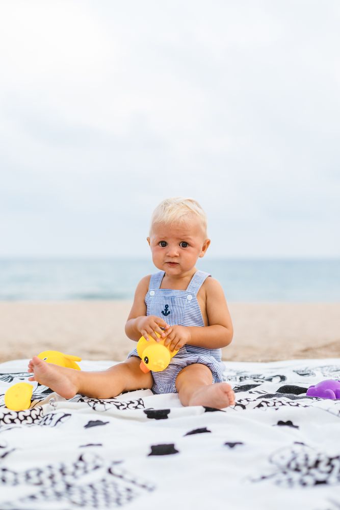 Baby boy playing with rubber ducks