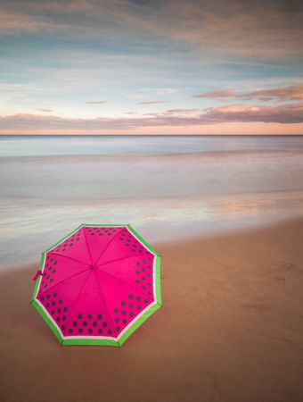 Umbrella on beach near sea