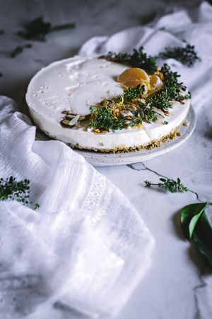 Tangerine cake decorated with whipped cream and sliced citrus