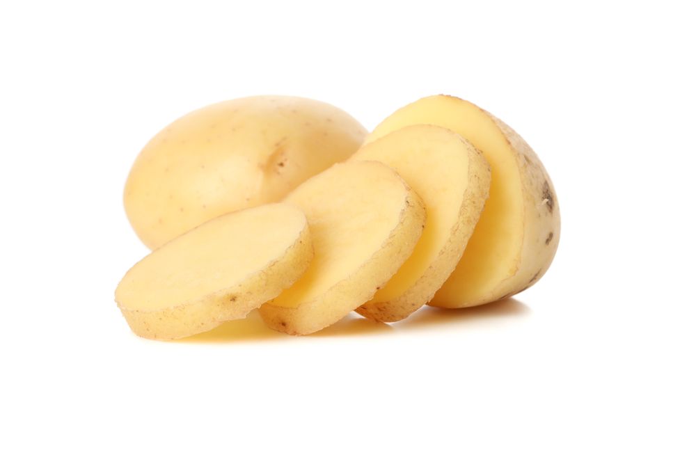 Whole and sliced potato on plain background